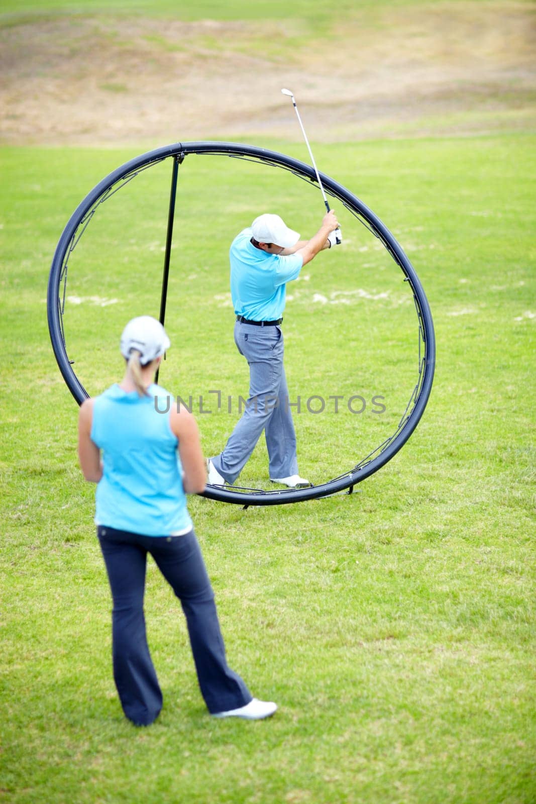Ring, woman or beginner golfer in golf course lesson for fitness, workout or exercise with a swing on field. Coaching, golfing game or athlete training with instructor for driving with a club stroke by YuriArcurs