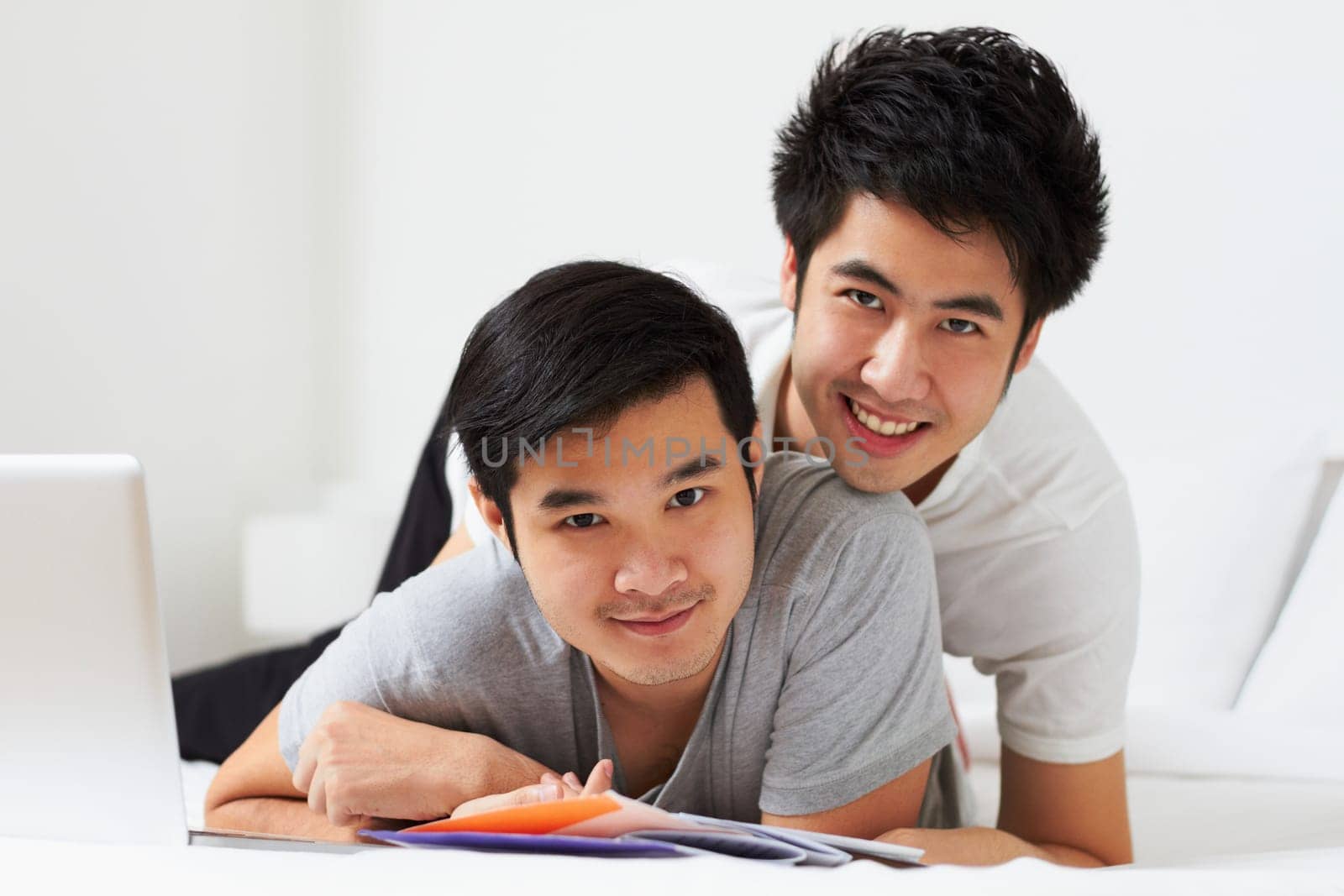 Portrait, lgbt and love with an asian couple learning together in their home while bonding over education. Study, happy or smile with a gay man and partner in a house, studying as university students.