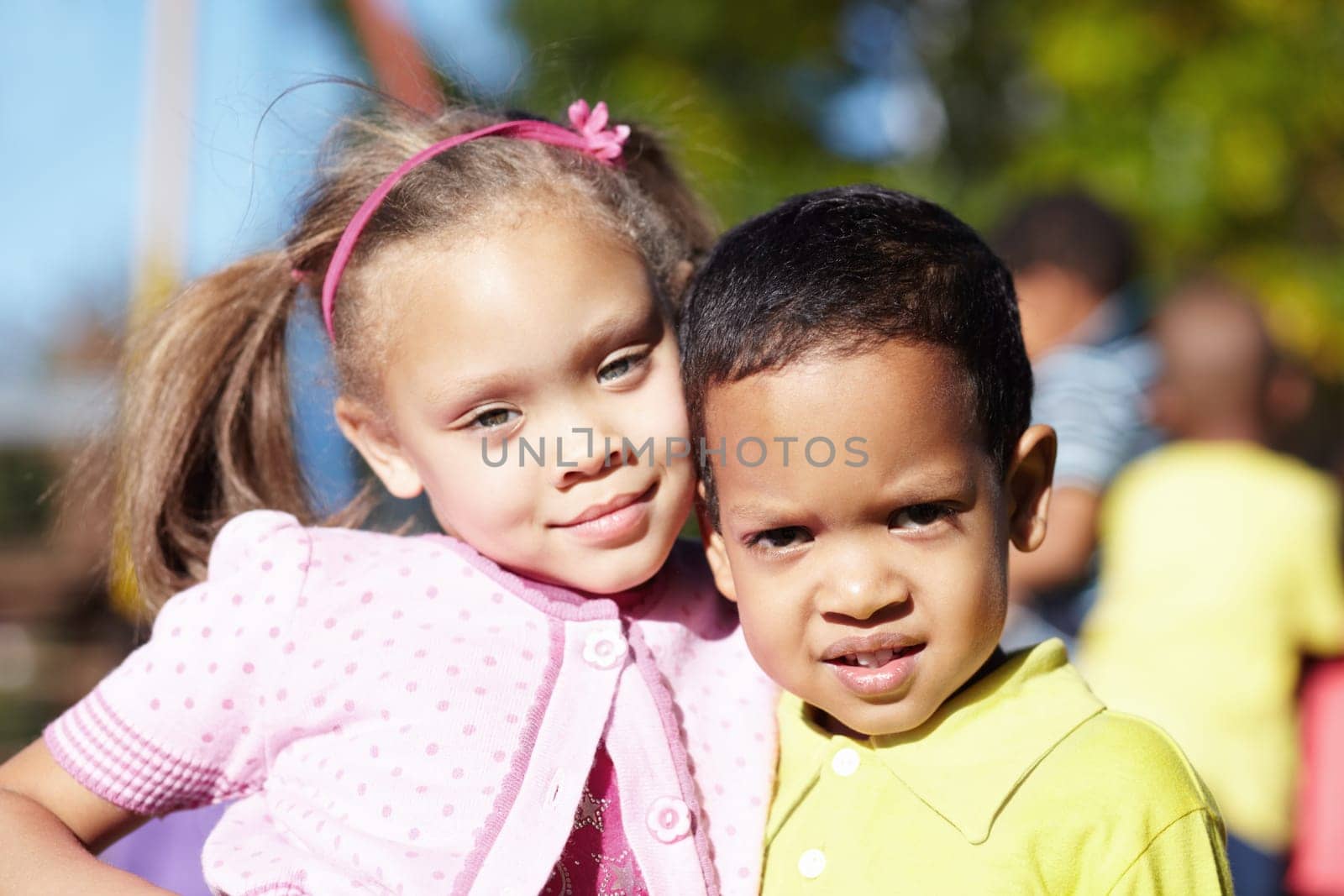 Happy, children and portrait of friends at a park playing outdoor at break time at kindergarten. Happiness, smile and kids embracing and having fun together in nature on the playground at school