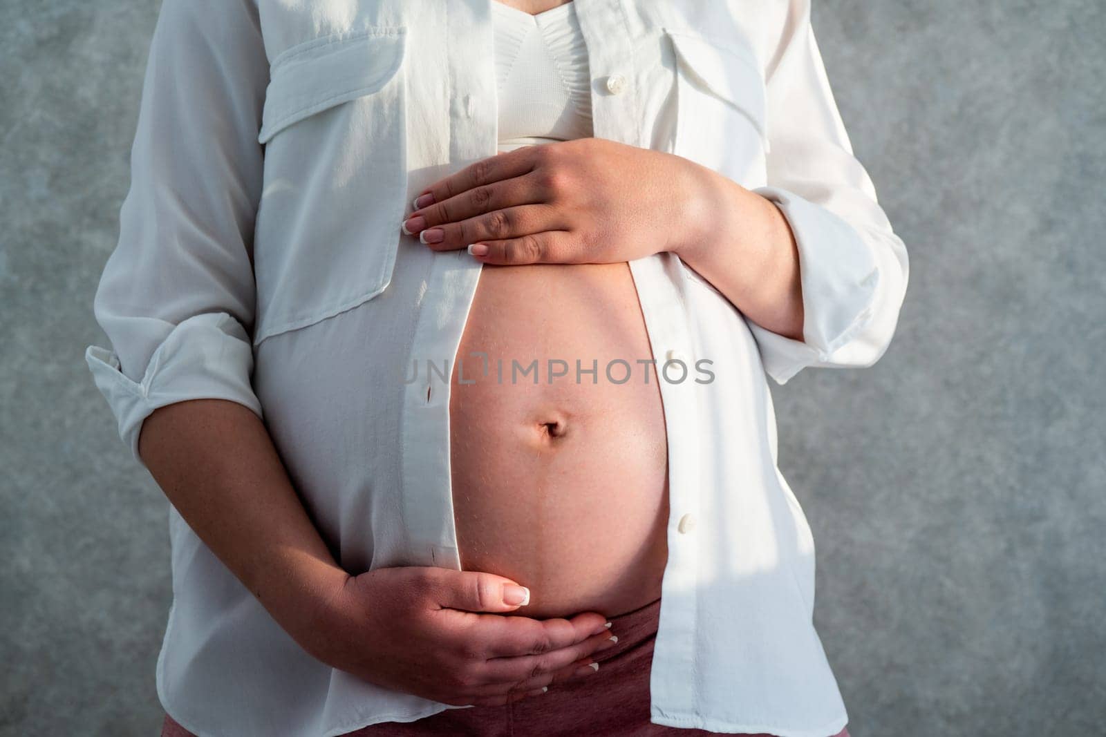 Pregnant woman belly. Pregnancy concept. Mid-section portrait of unrecognizable woman during last months of pregnancy