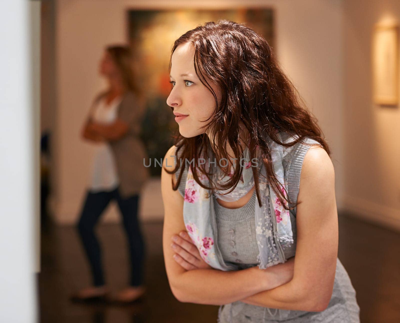 Museum, art and a woman in a painting gallery, looking at photography in creative appreciation. Artistic, design and culture with an attractive young female at an expo or modern artwork exhibition.