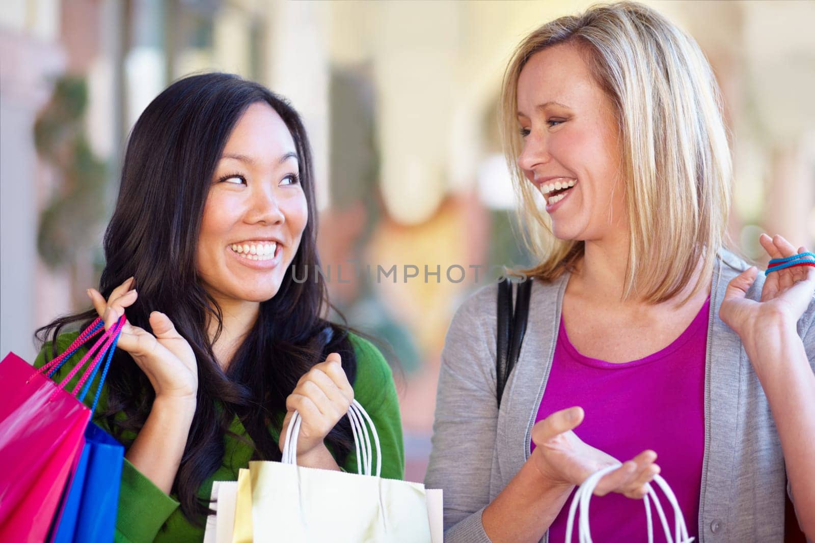 Happy, sale and women with bags from shopping in the city or mall and excited about a deal. Smile, conversation and diversity with female friends talking while at a shop for clothes and fashion.