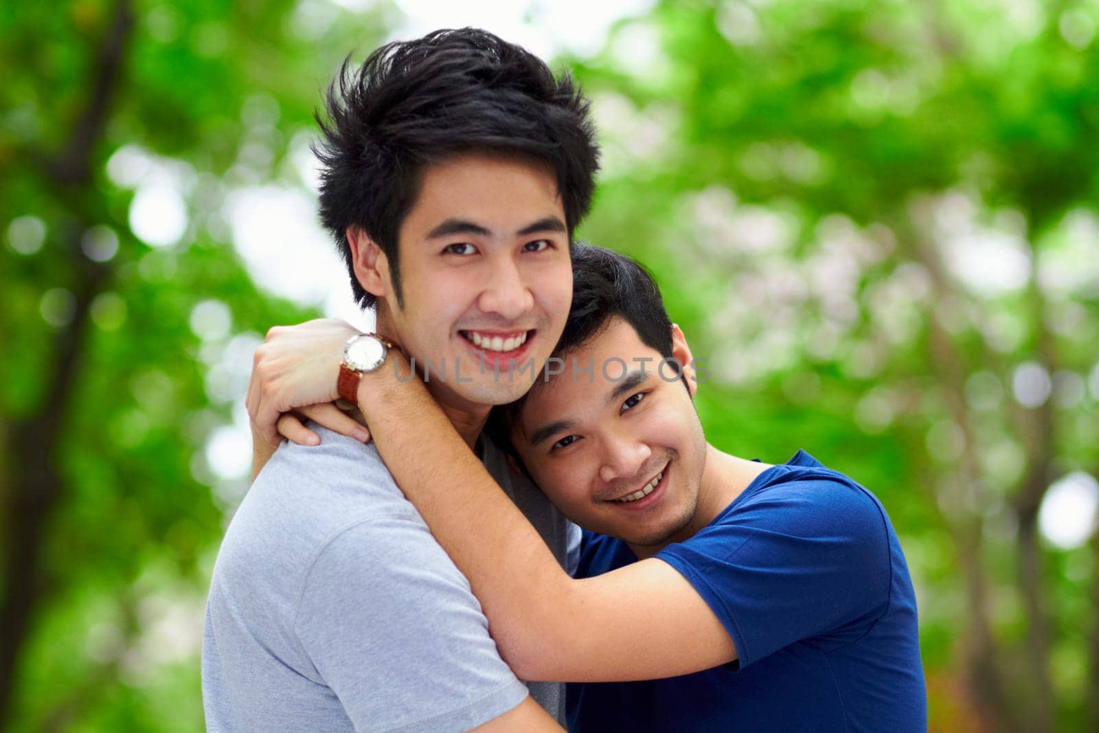 Asian men, gay couple and hug by trees, portrait and woods with love, care and bonding in summer sunshine. Happy Japanese man, romance and relax together in forrest with lgbtq, nature and holiday.