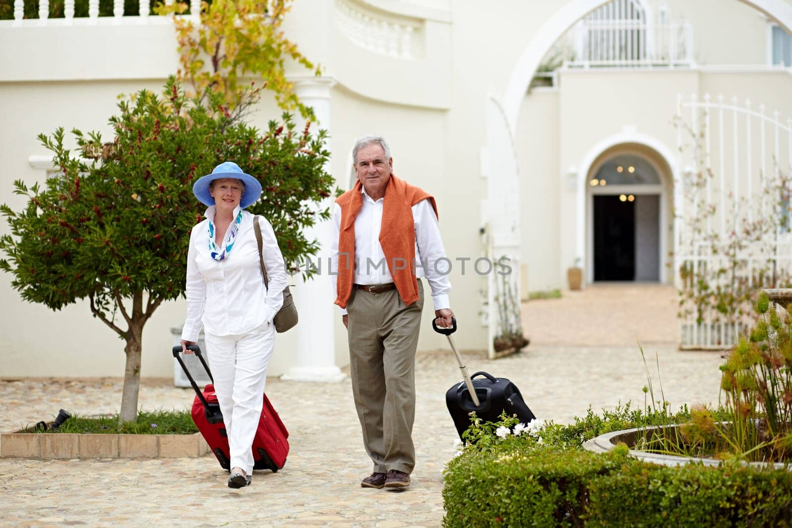 Hotel, vacation and elderly couple walking with suitcase in a holiday location happy in retirement and travel together. Bag, smile and senior people on a journey or man and woman walk in happiness.