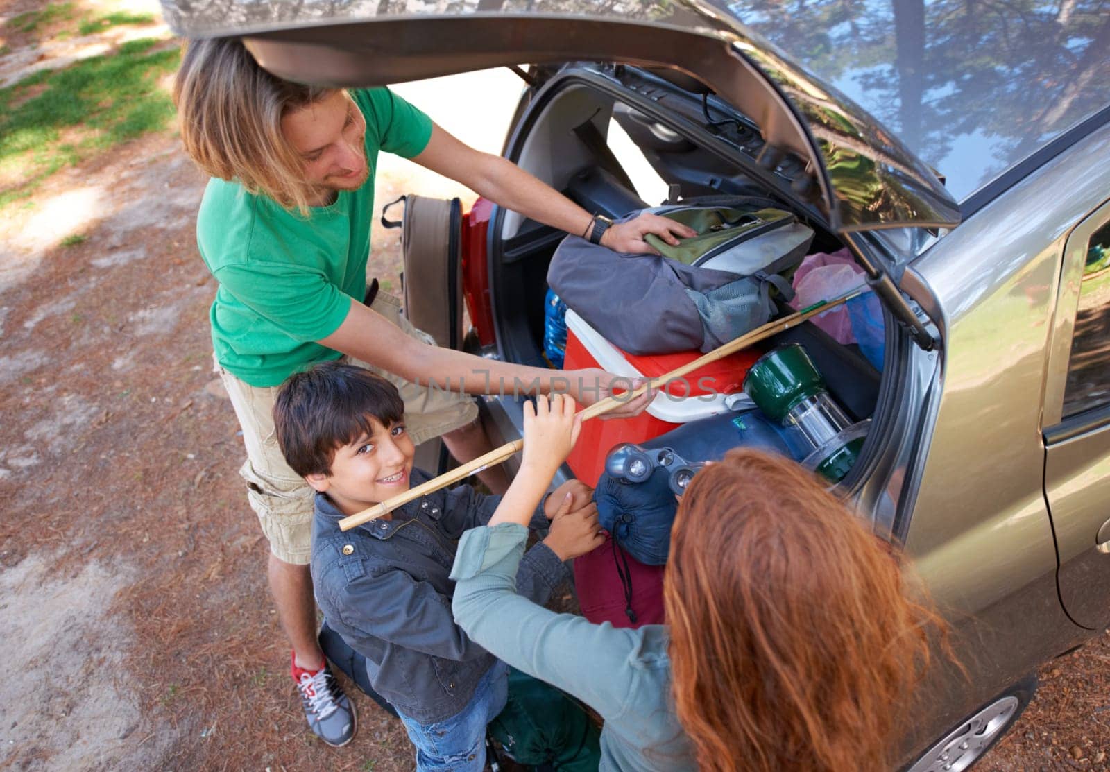 Happy family, car and packing for camping road trip, holiday or vacation above in nature outdoors. Top view of dad and kids getting ready for travel, camp adventure or getaway together in the forest.