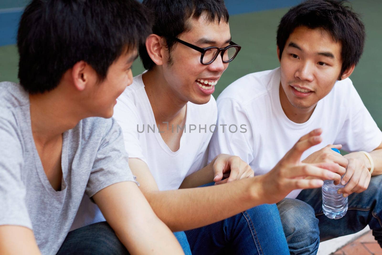 Smile, talking and a group of asian friends sitting outdoor on university campus as scholarship students. Funny, conversation or bonding with happy young men outside together during college break.