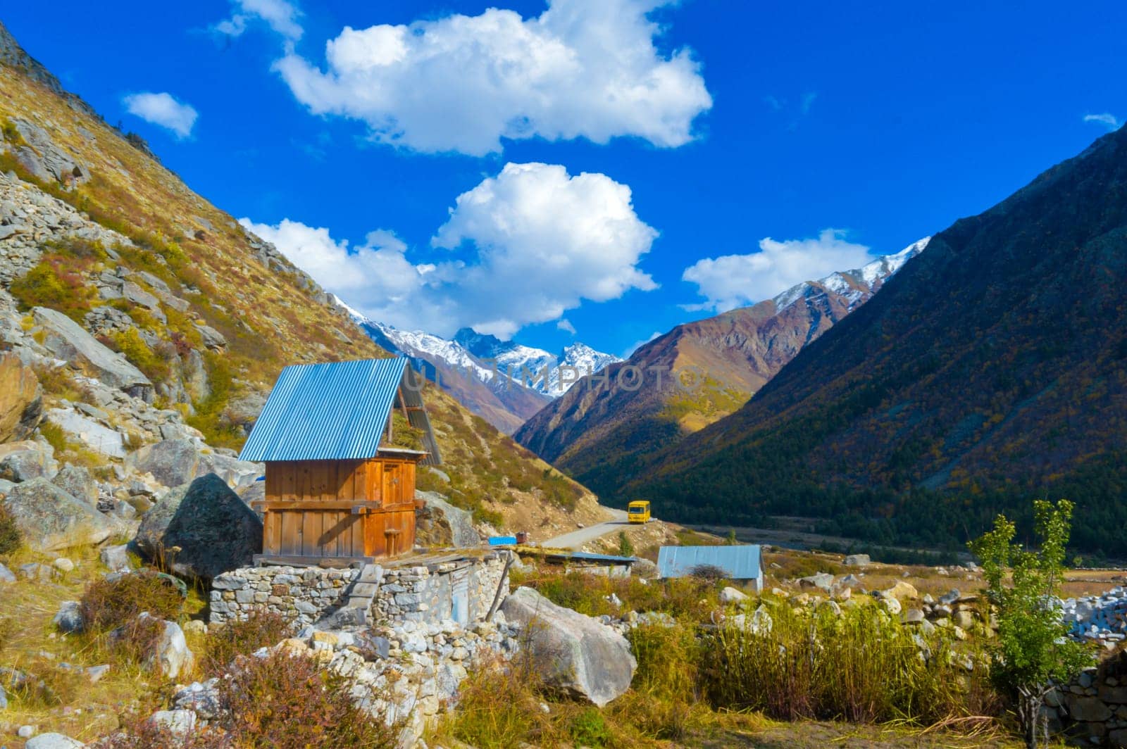 A small cabin room in a mountain valley against blue sky and flying clouds in the background. Chitkul Village Himachal Pradesh India South Asia Pacific