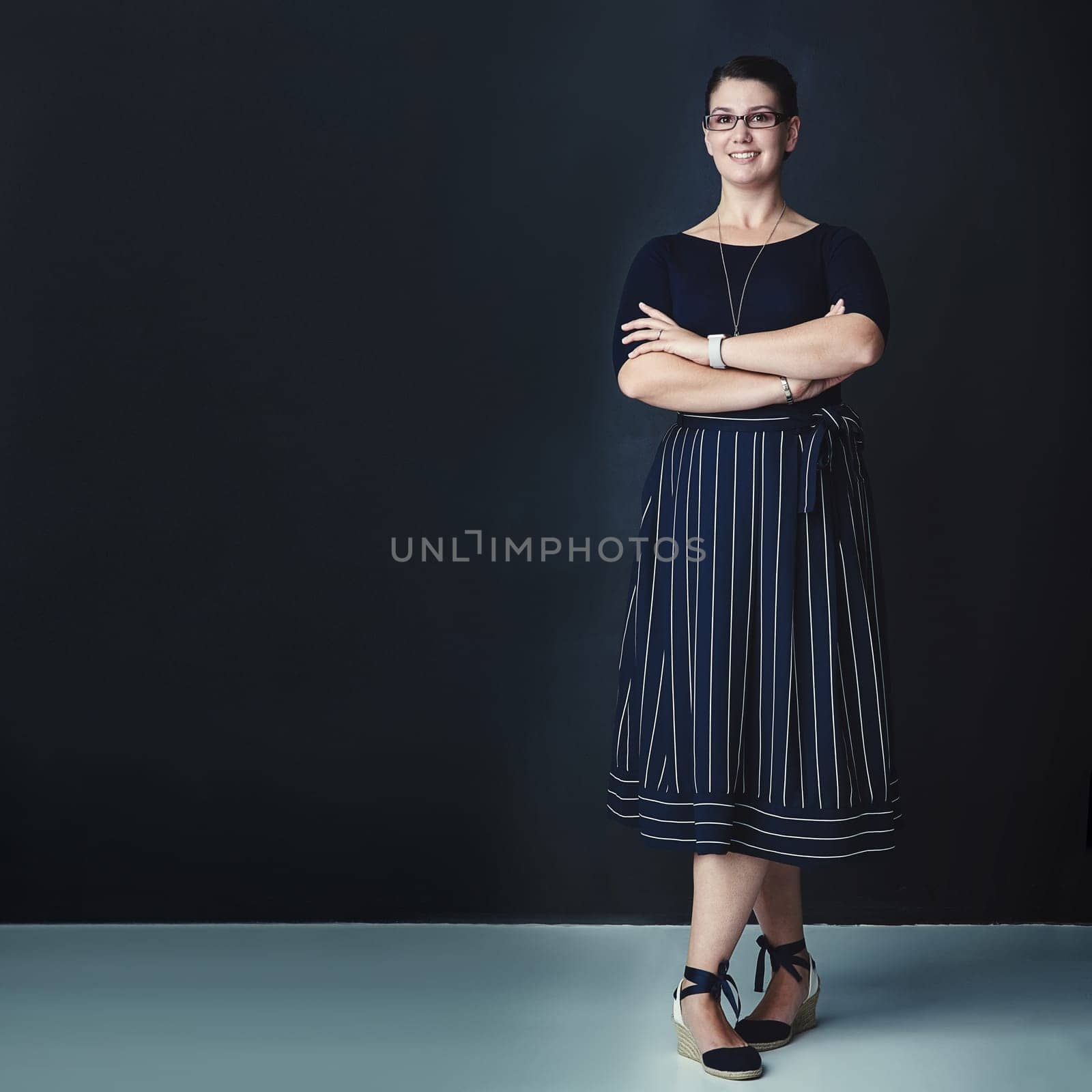 Exemplifying greatness. Studio portrait of a corporate businesswoman posing against a dark background. by YuriArcurs