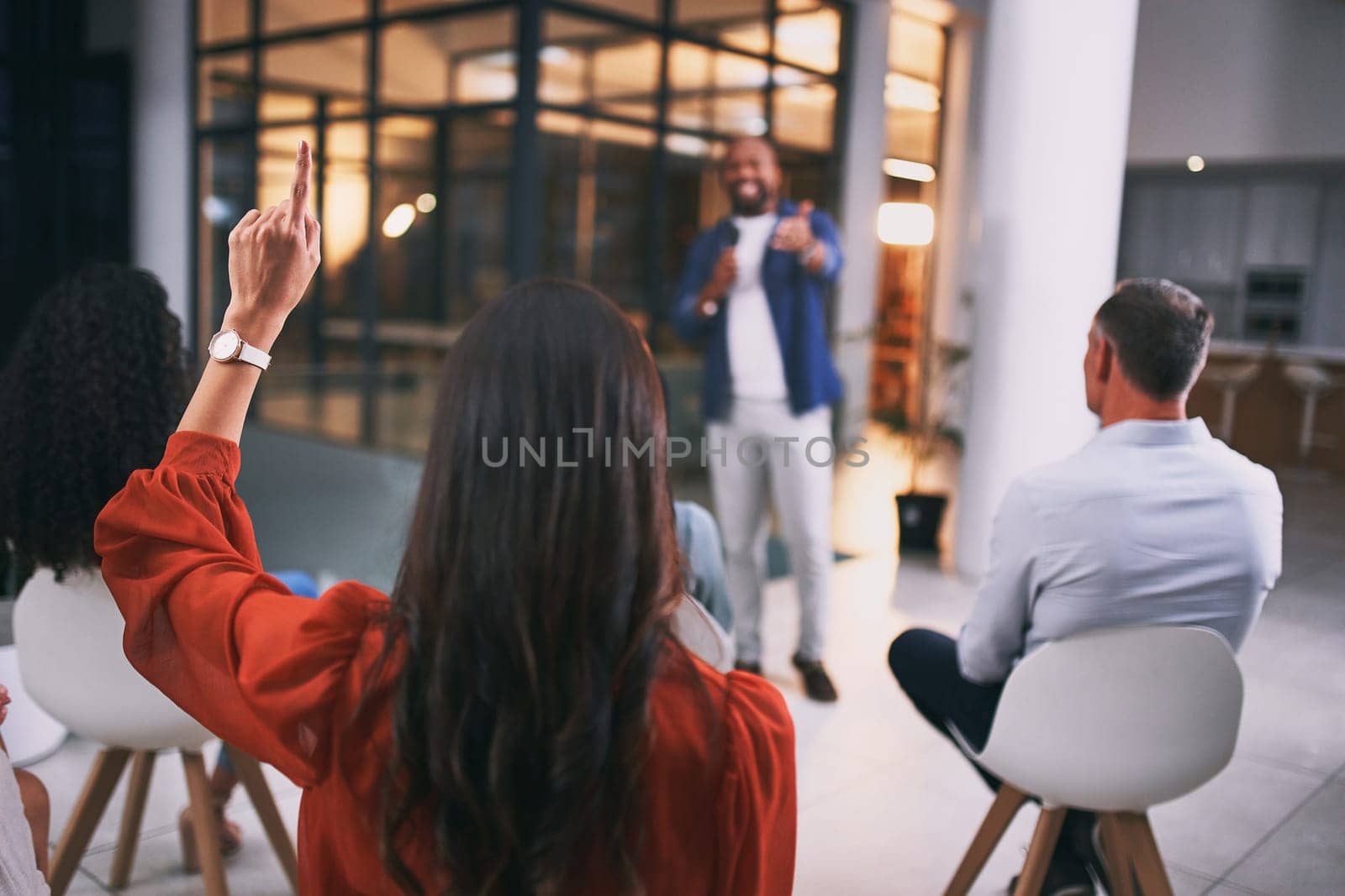Whats your question. an unrecognizable businessperson raising their hand to ask a question during a conference at work. by YuriArcurs