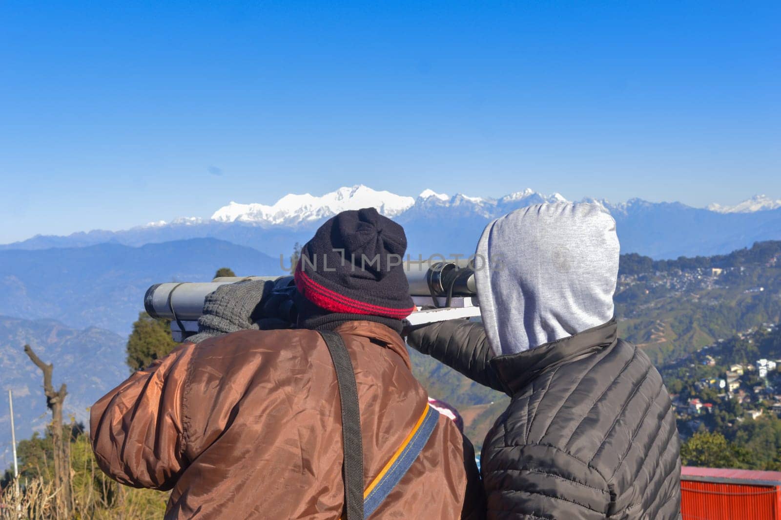 Tourist people looking through binoculars. Rear view. by sudiptabhowmick