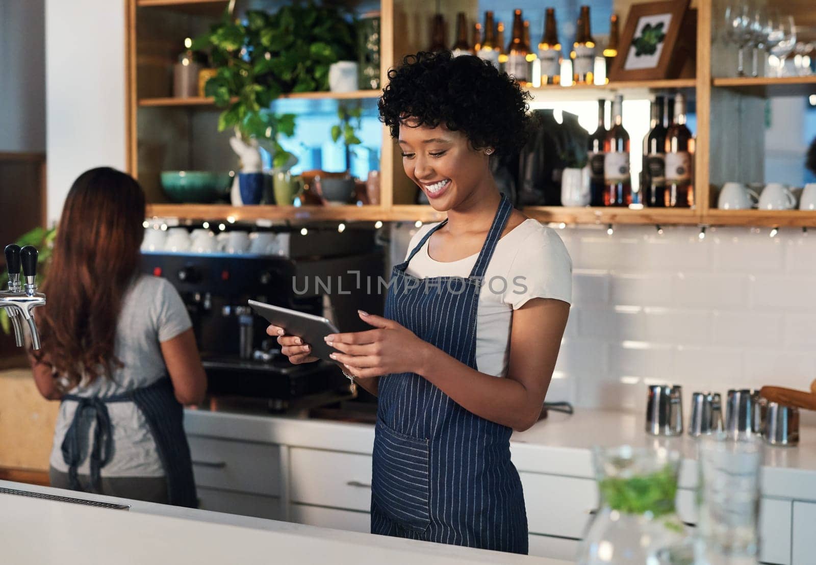 Happy woman, tablet and waitress in management at cafe for order, inventory or checking stock at restaurant. African female person, barista or manager on technology for small business at coffee shop by YuriArcurs