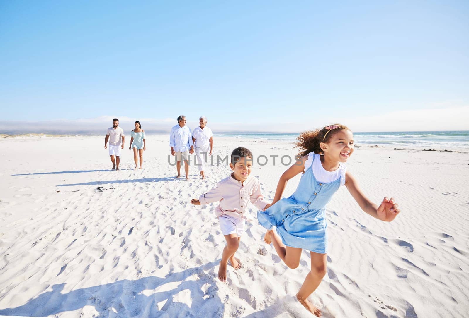 Excited, beach or happy children running or playing in summer with happiness or joy in nature. Kids, lovely girl or young boy bonding with a happy girl or playful sister walking as a family together by YuriArcurs