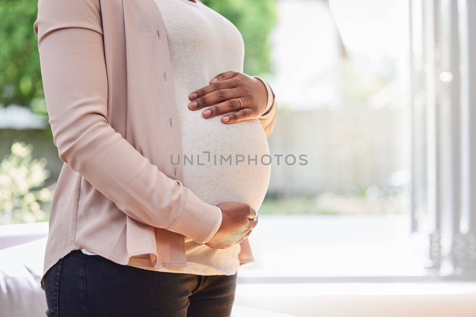Pregnant, stomach and woman frame her belly or ready for motherhood or hands on tummy in the living room at home. Maternity, pregnancy and female abdomen for family planning or prenatal or life by YuriArcurs