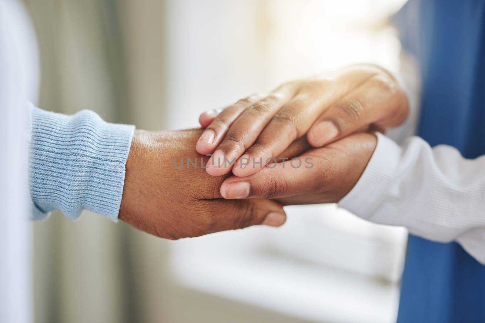 Patient, nurse and holding hands for support, healthcare or empathy at nursing home. Medical worker and person together for trust, therapy and counseling or help for health or cancer results.