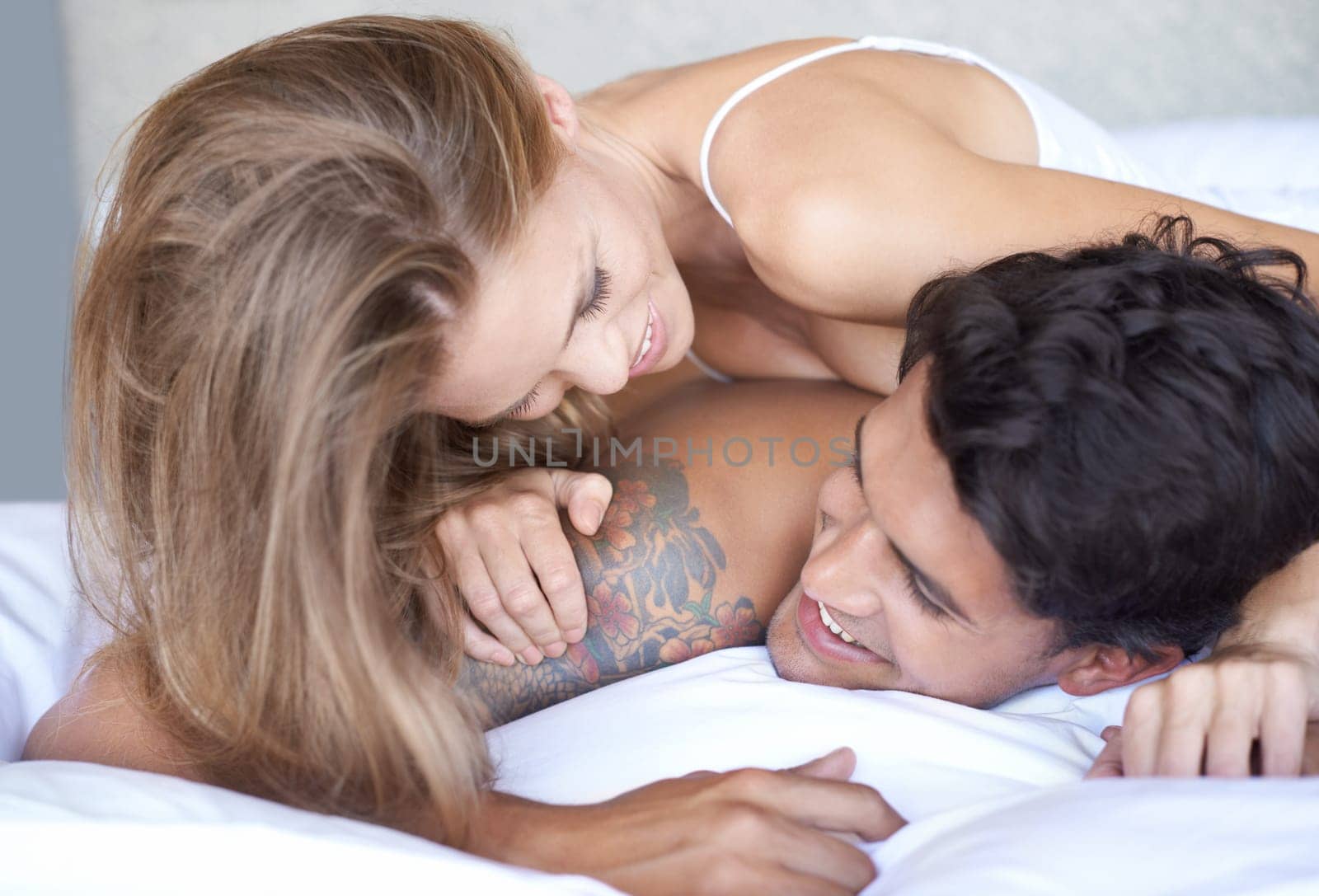 Happiness is being with you. A young couple acting playful in bed