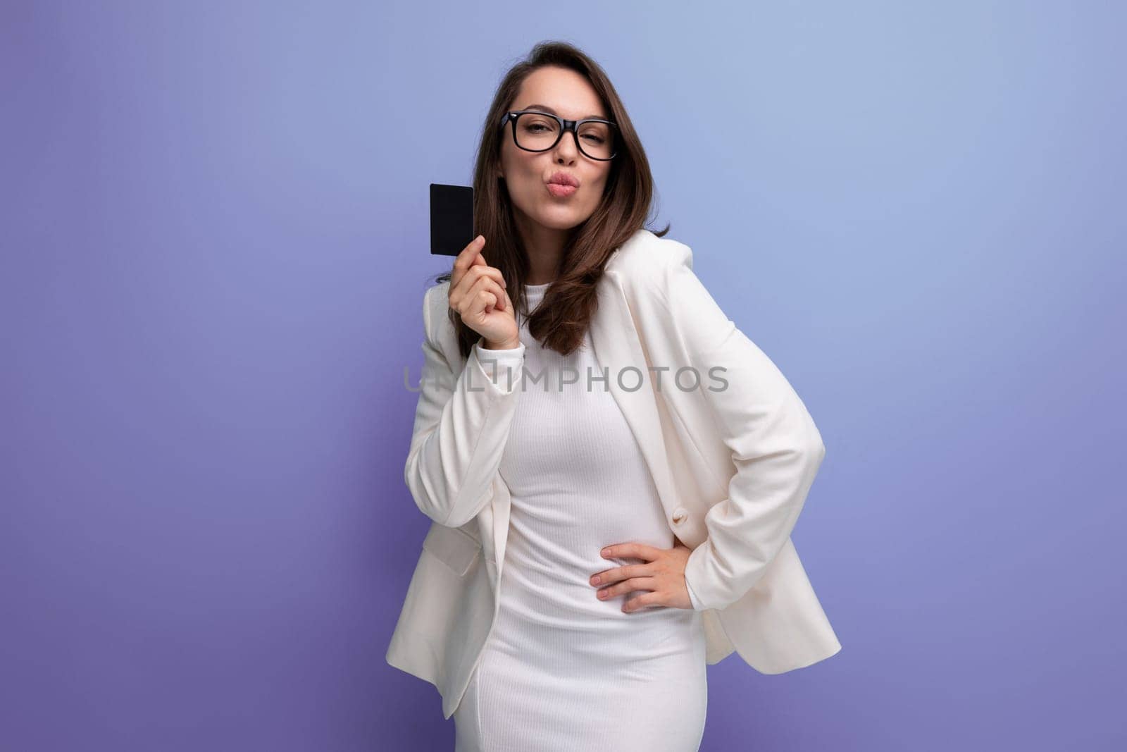 portrait of successful young business woman proudly standing with money card with salary.