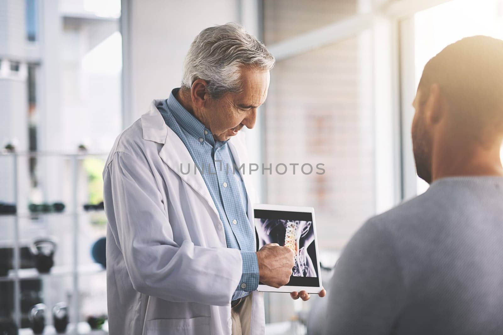 It doesnt look too bad. a senior doctor giving his male patient a thorough checkup during his consultation