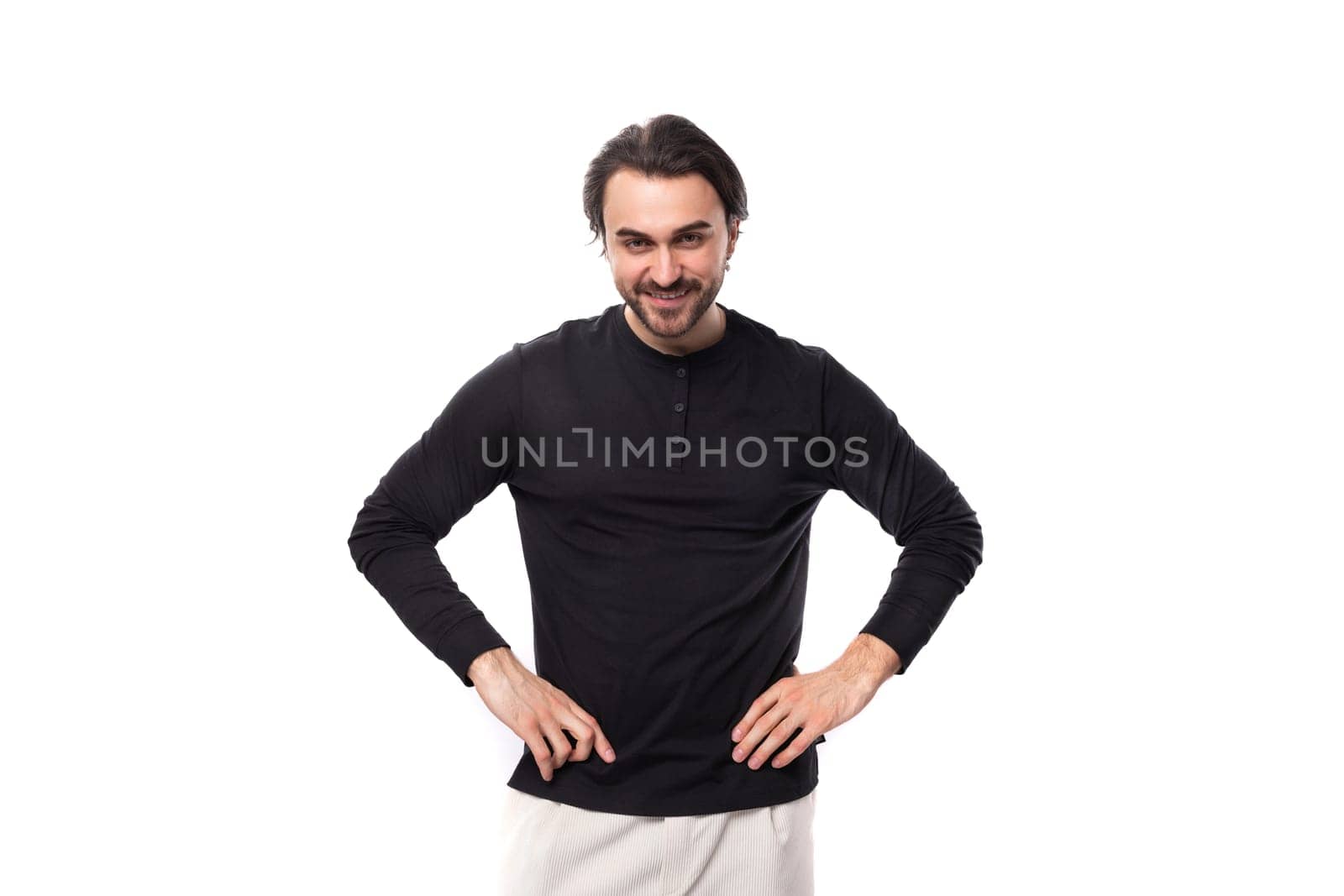 young bearded brutal european macho man with ear piercing and with black hair on isolated white background with copy space.