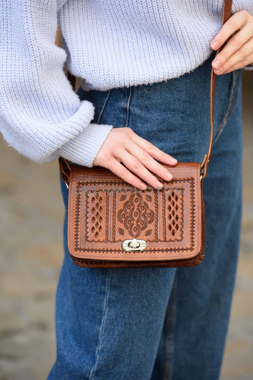 a red-haired girl in a blue jeans and a sweater poses outside with a small leather handbag by Ashtray25