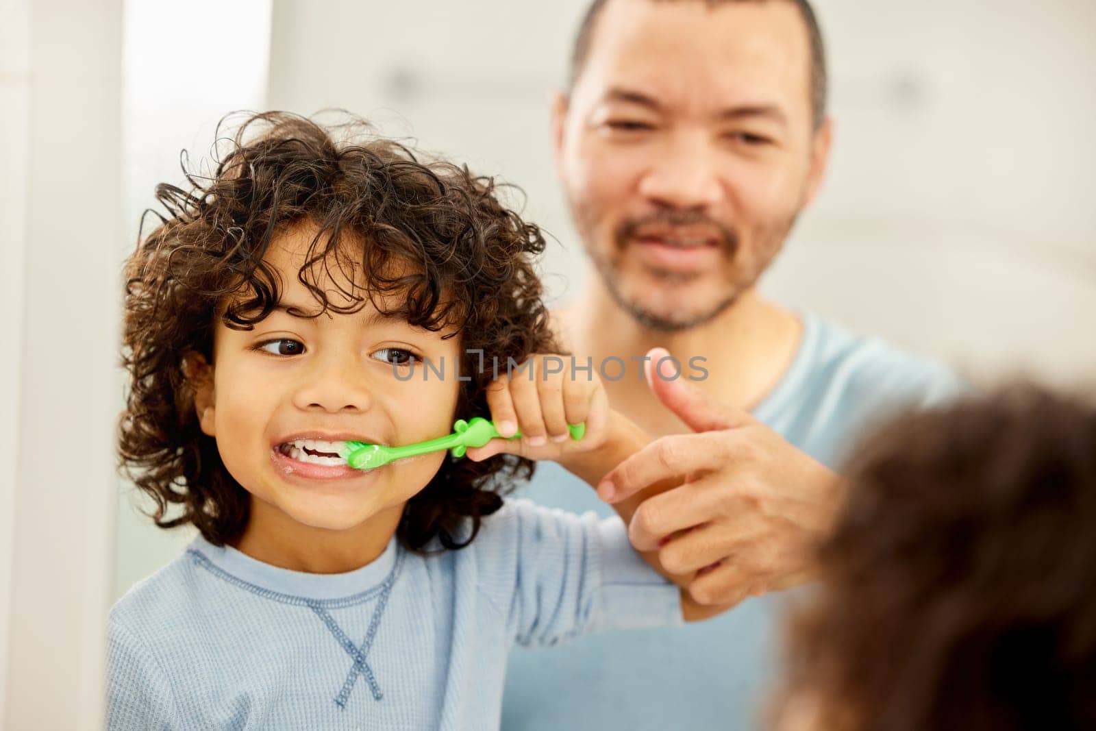 Child, brushing teeth and father learning in a bathroom with dental health and cleaning. Morning routine, toothbrush and kid with dad together showing hygiene care at a mirror at home with grooming.
