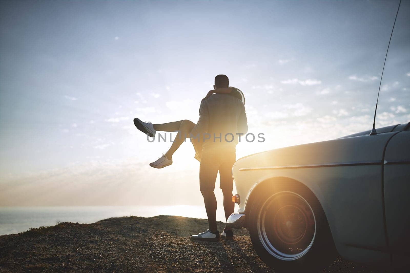 Live with no excuses and travel with no regrets. a young couple making a stop at the beach while out on a road trip. by YuriArcurs
