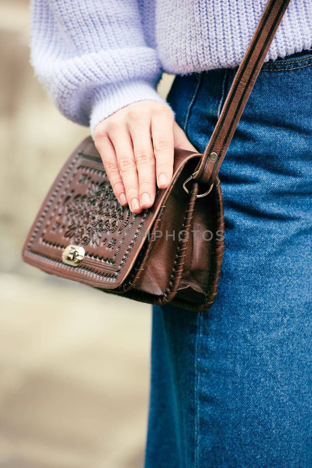 a red-haired girl in a blue jeans and a sweater poses outside with a small leather handbag by Ashtray25