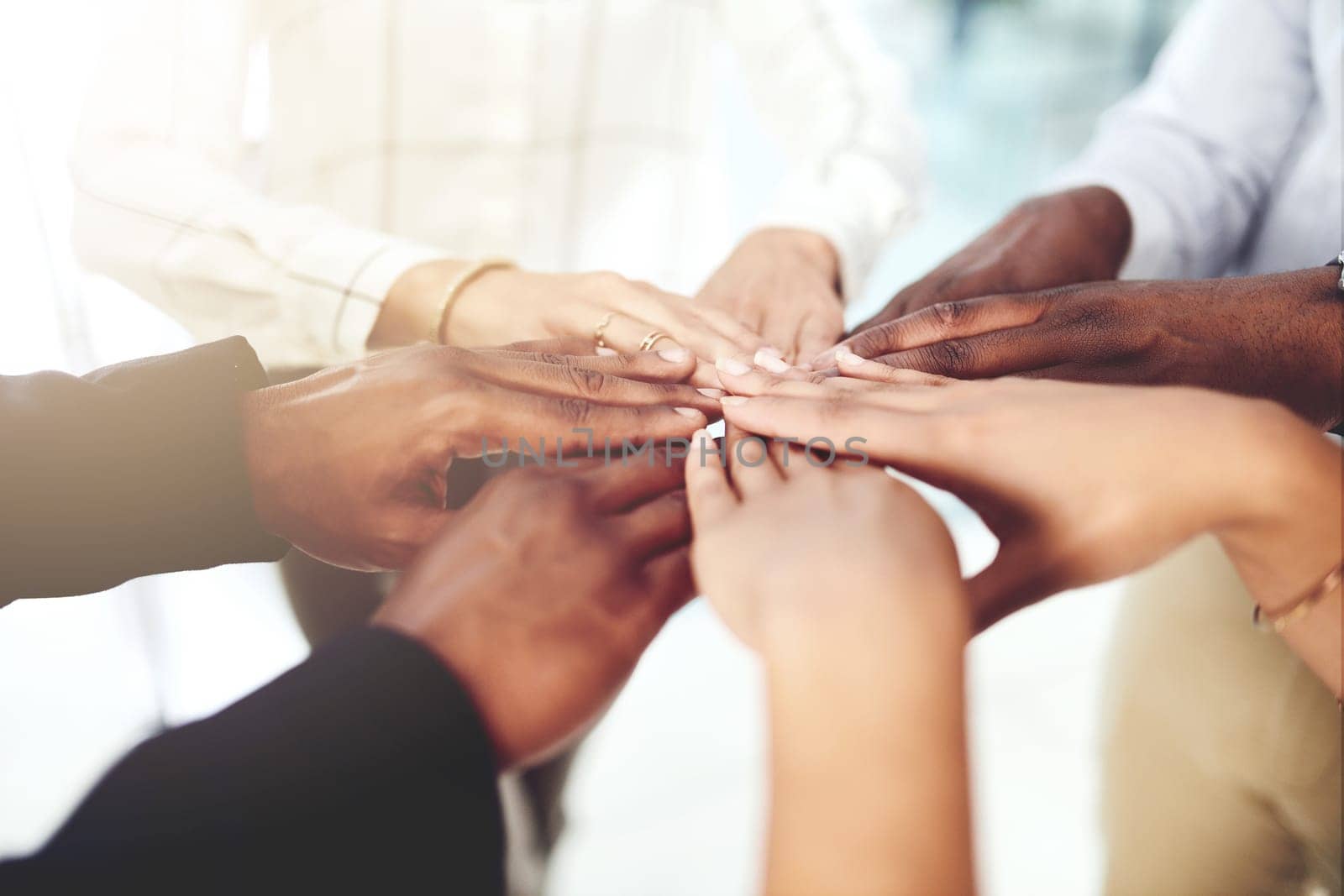 Teamwork allows us all to shine. Closeup shot of a group of businesspeople joining their hands together in a huddle