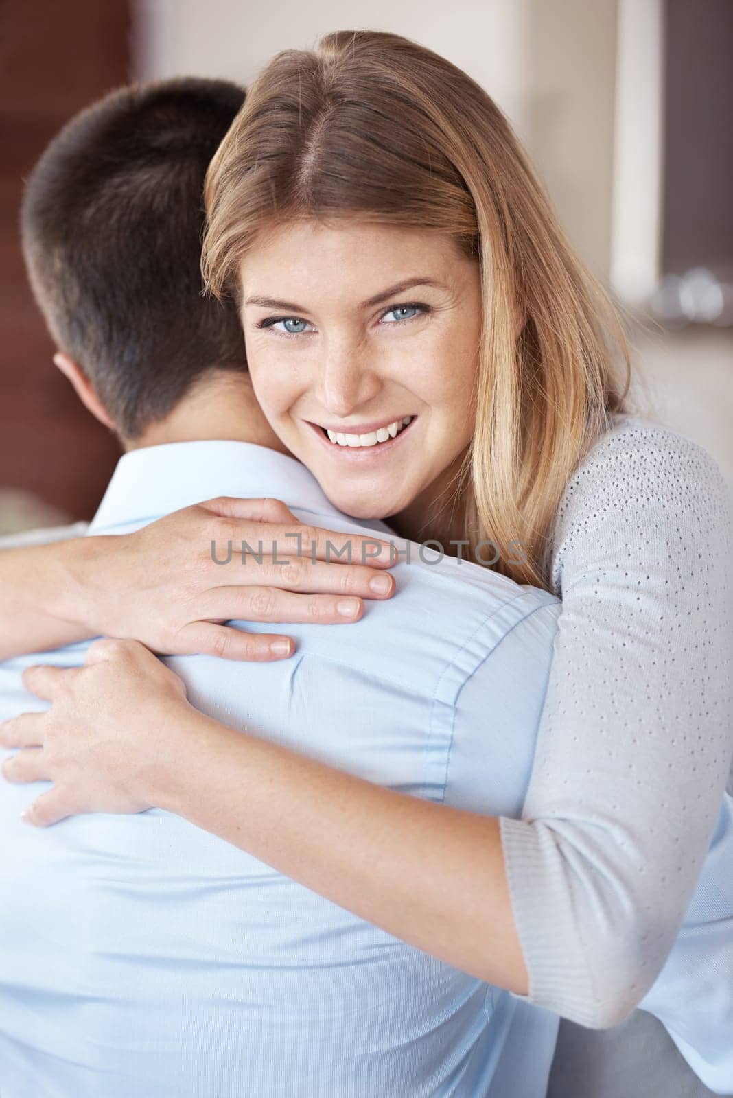 Nothing better than a morning hug from my husband. Portrait of a smiling woman hugging her boyfriend