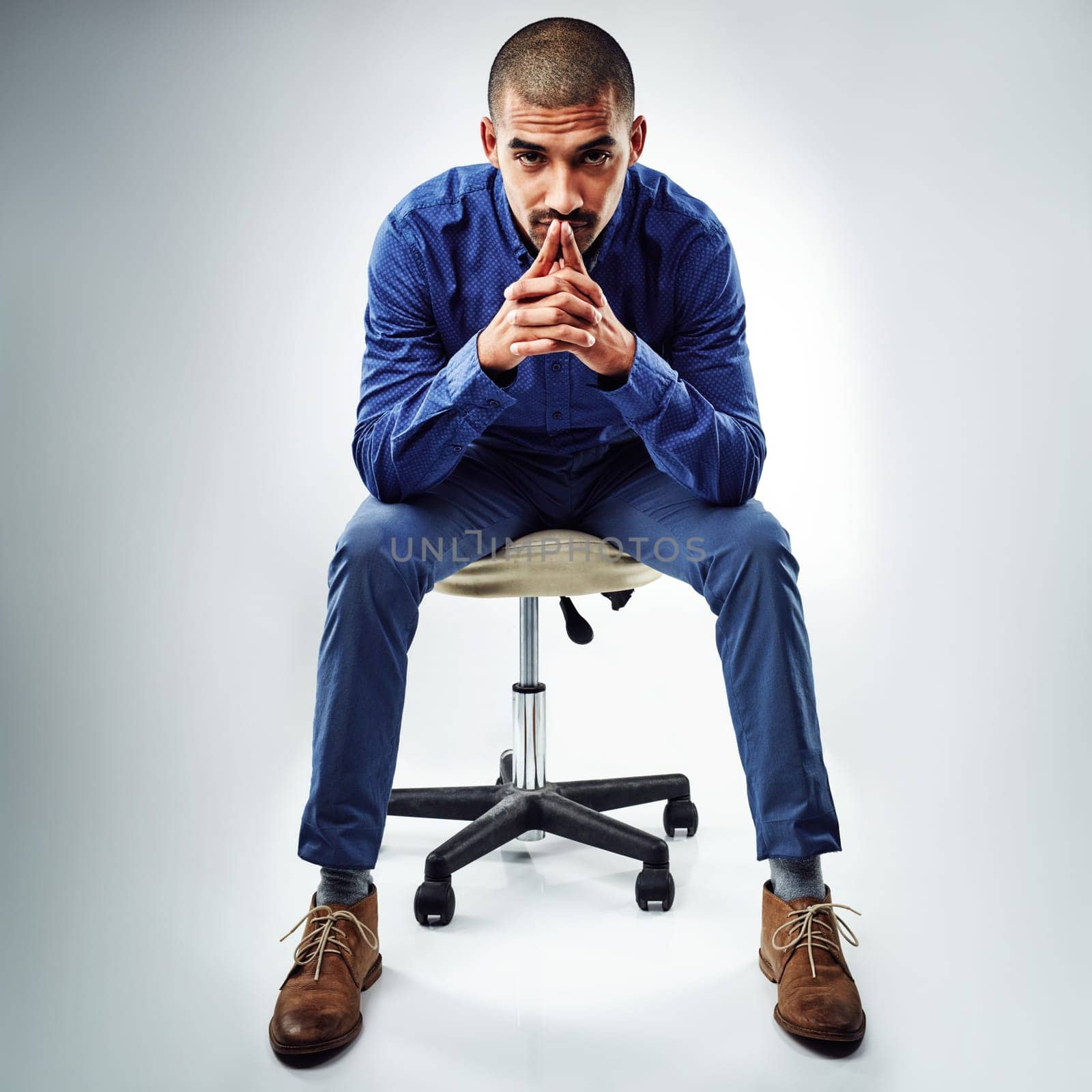 Failure is another steppingstone to greatness.a young businessman posing against a grey background. by YuriArcurs