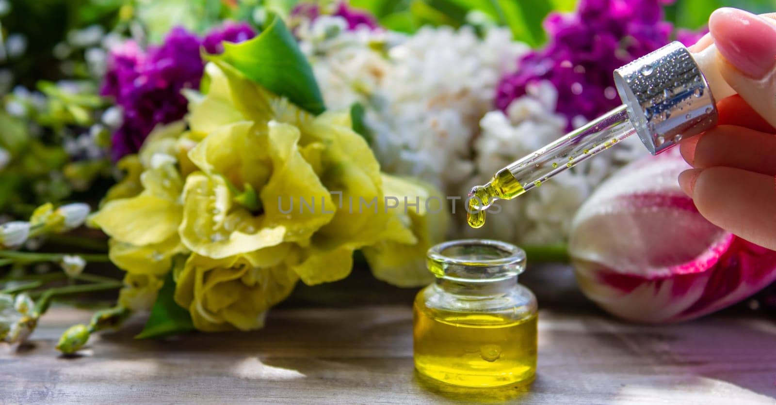 essential oil of flowers drips into a jar. selective focus. nature