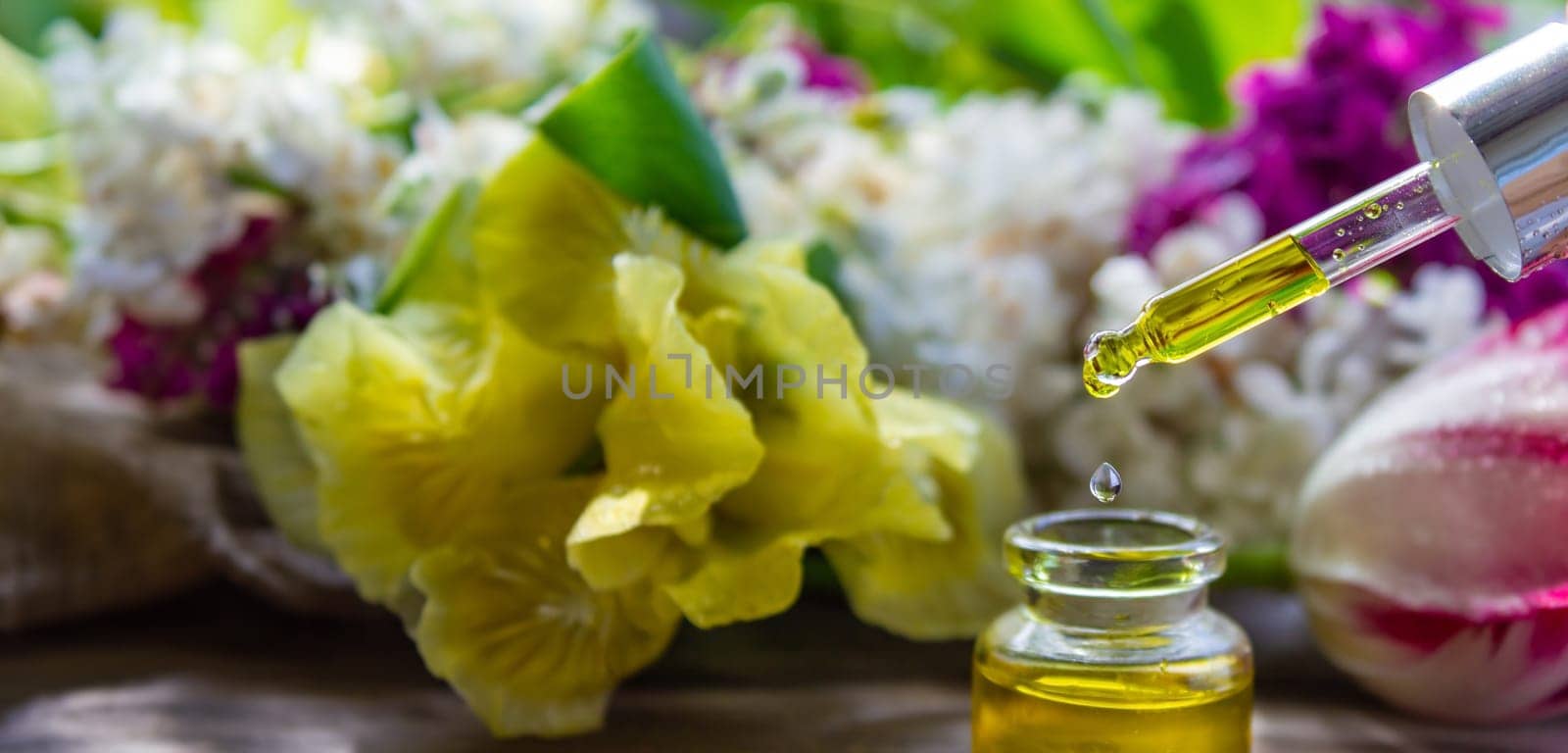 essential oil of flowers drips into a jar. selective focus. nature