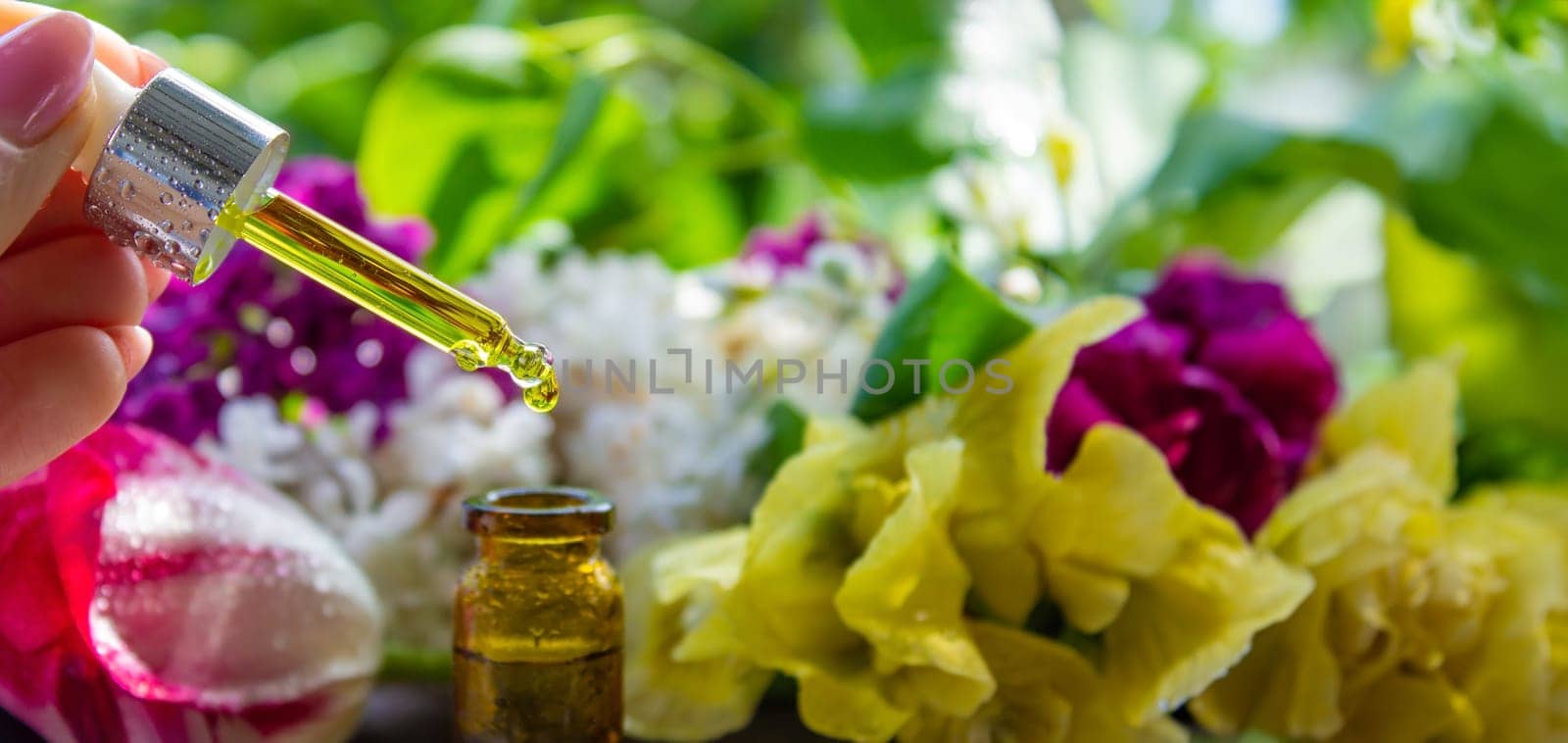 essential oil of flowers drips into a jar. selective focus. nature