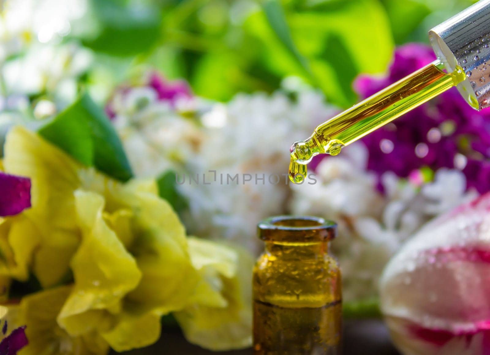 essential oil of flowers drips into a jar. selective focus. nature
