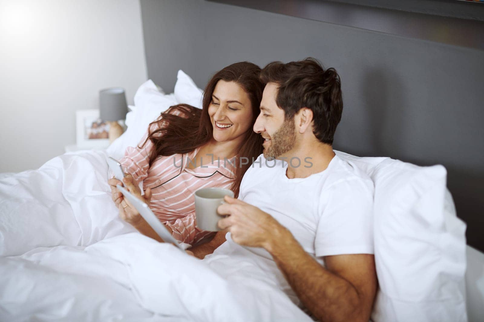 Look at this post. a couple using their wireless devices while lying in bed