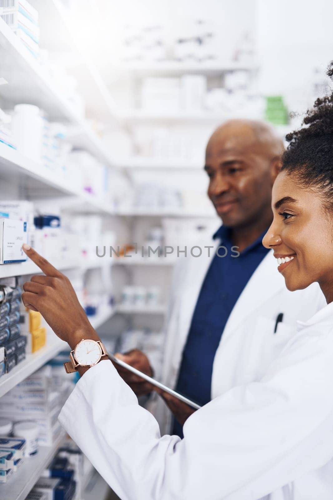 This must be it. two pharmacists doing inventory in a pharmacy with a digital tablet
