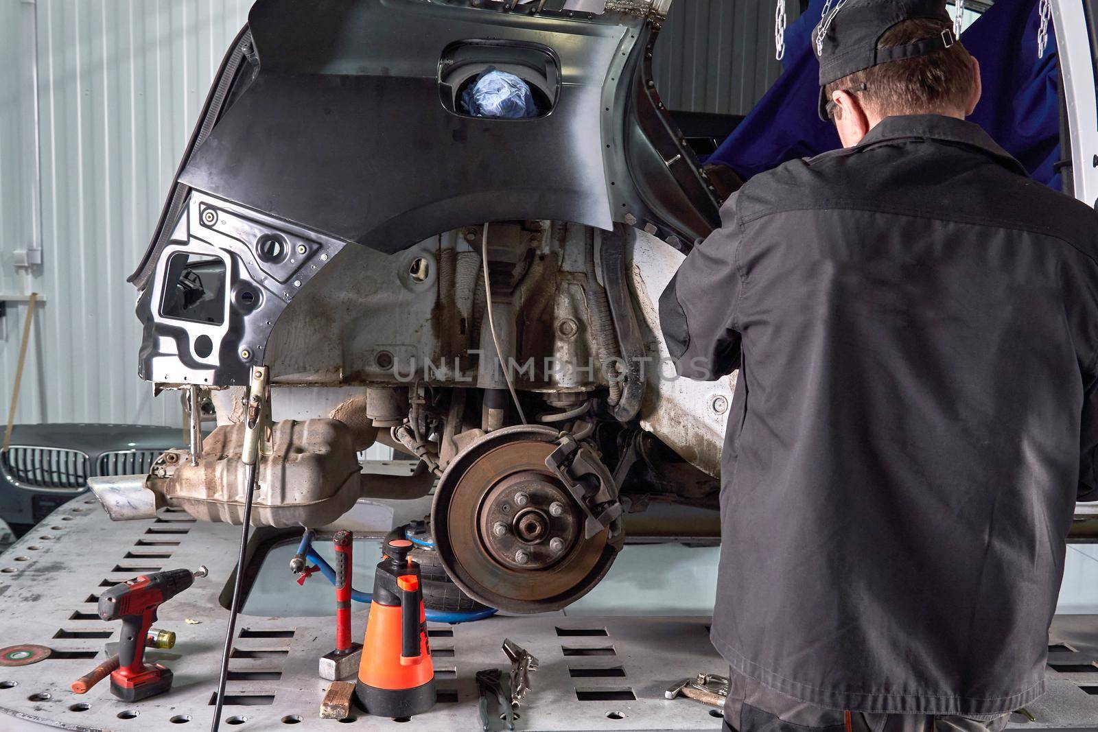 Cutting metal part with sparks in car service station