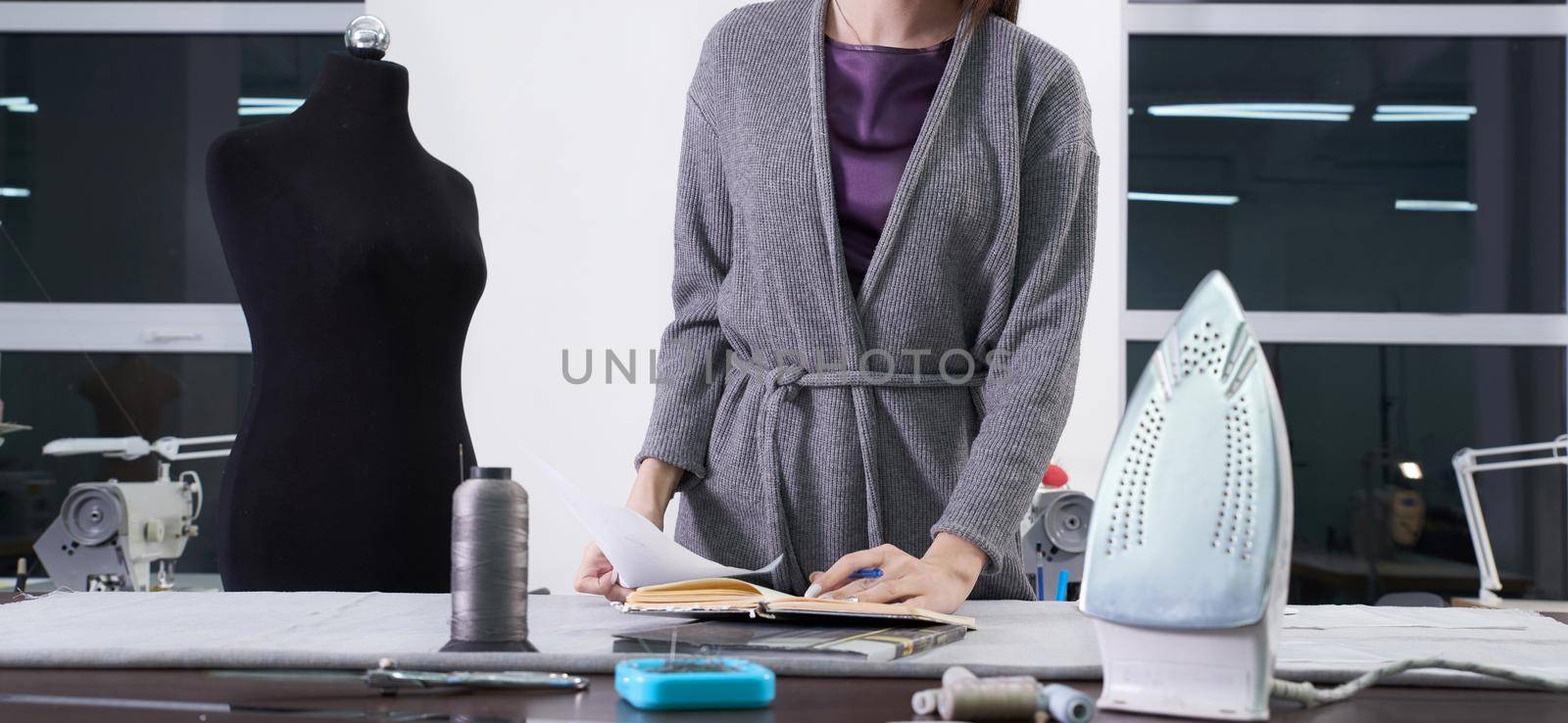 Smiling tailor at her workshop