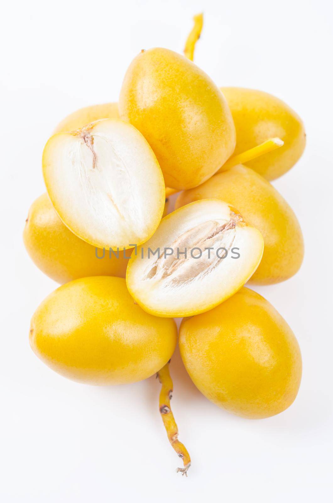 Fresh date palm fruits on white background.
