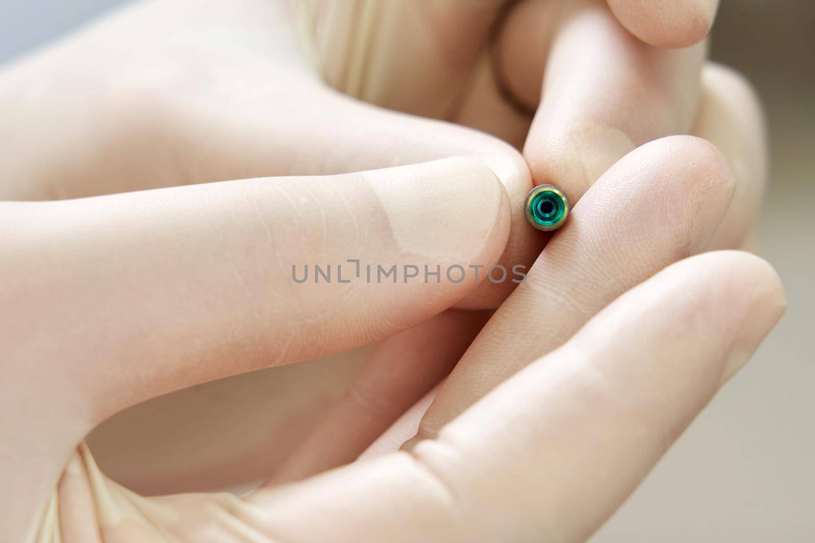 Closeup view of dentist holding dental implant in medical clinic