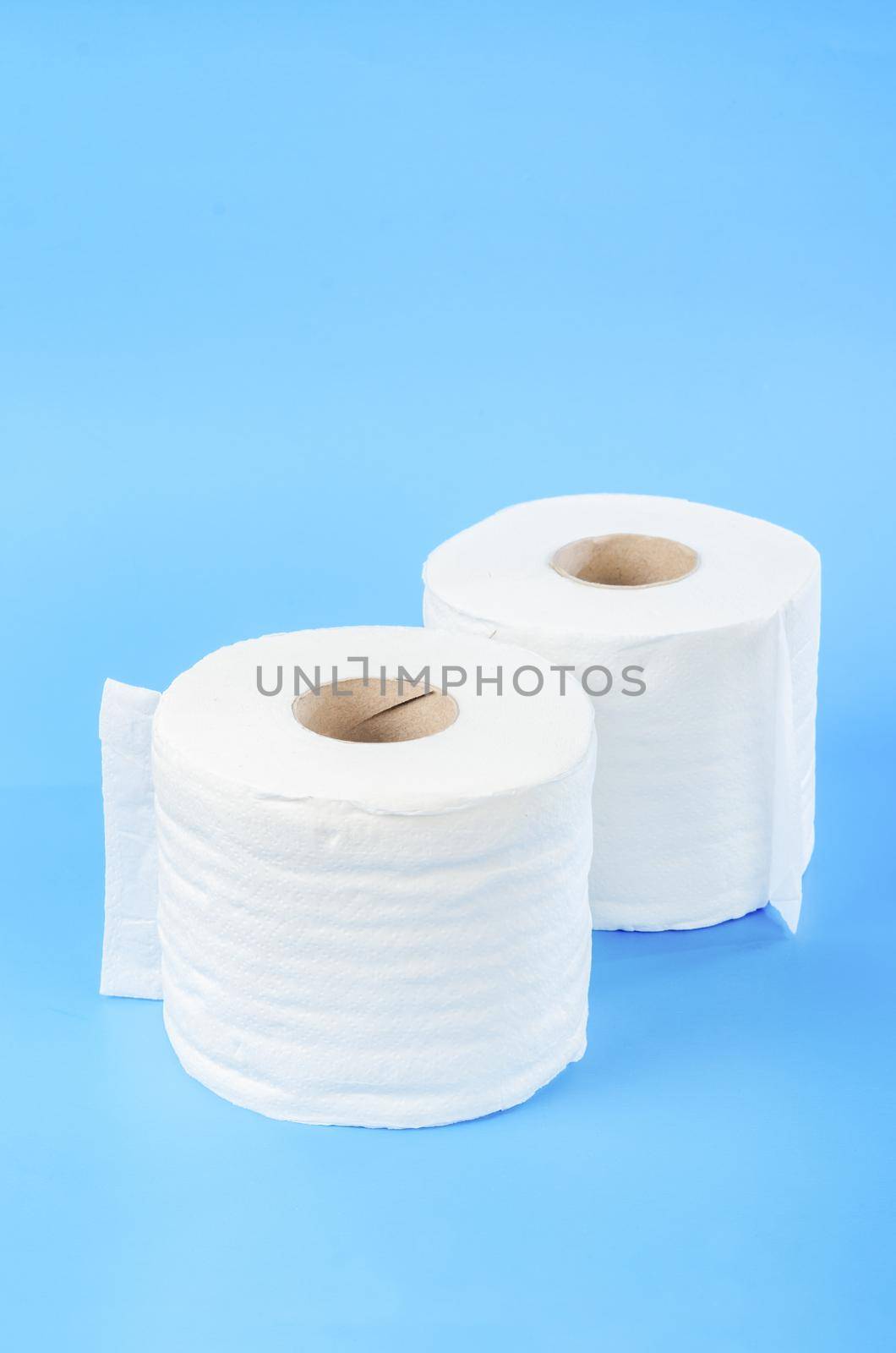 Tissue paper rolls on blue background.