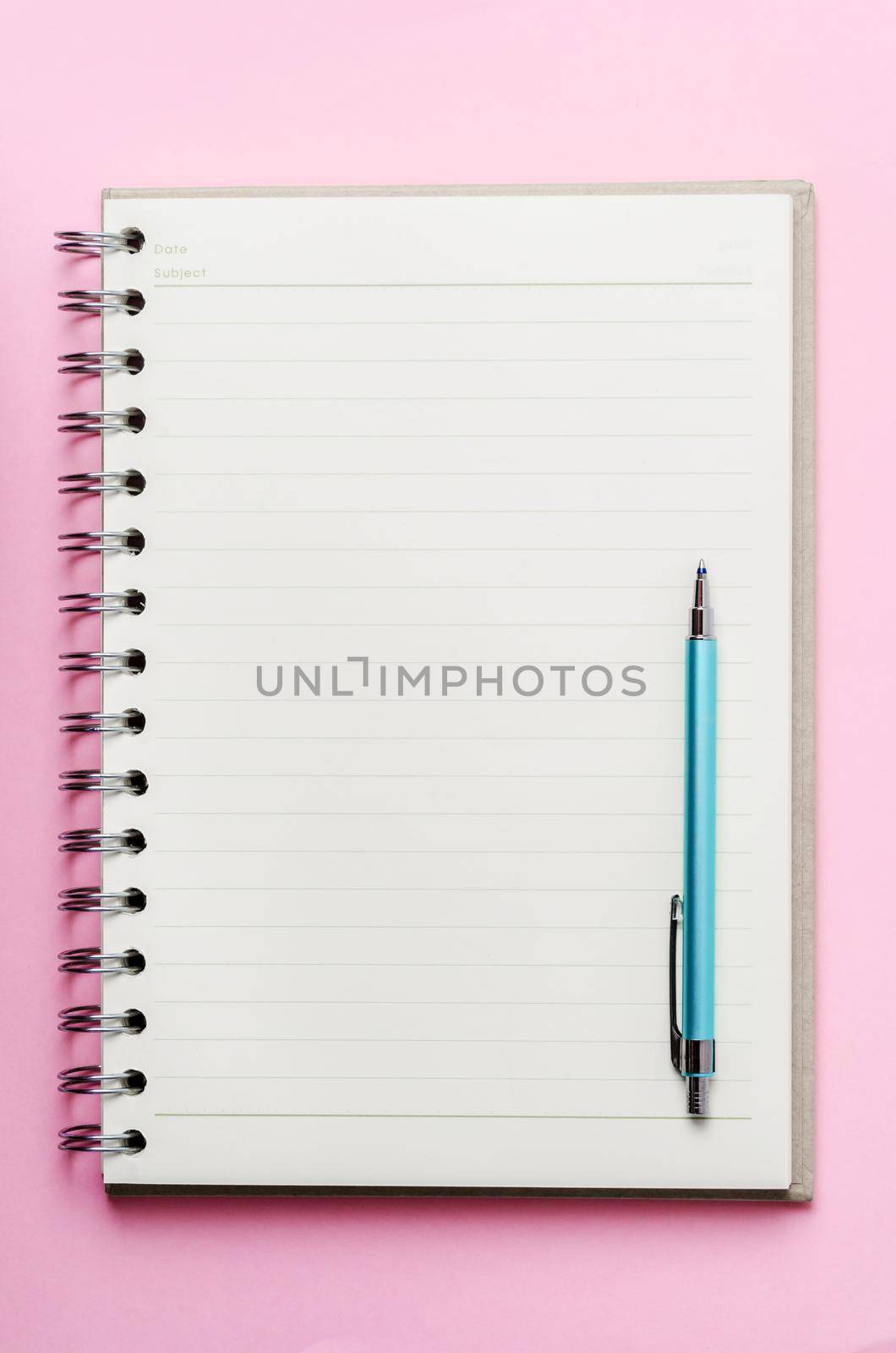 open book with blank pages and pen on pink color background.