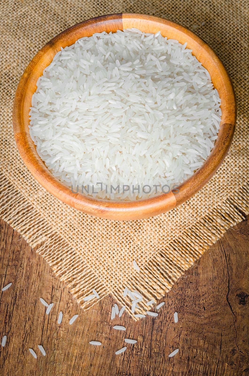 Organic Thai Jasmine rice grain in wooden bowl preparing for cooked