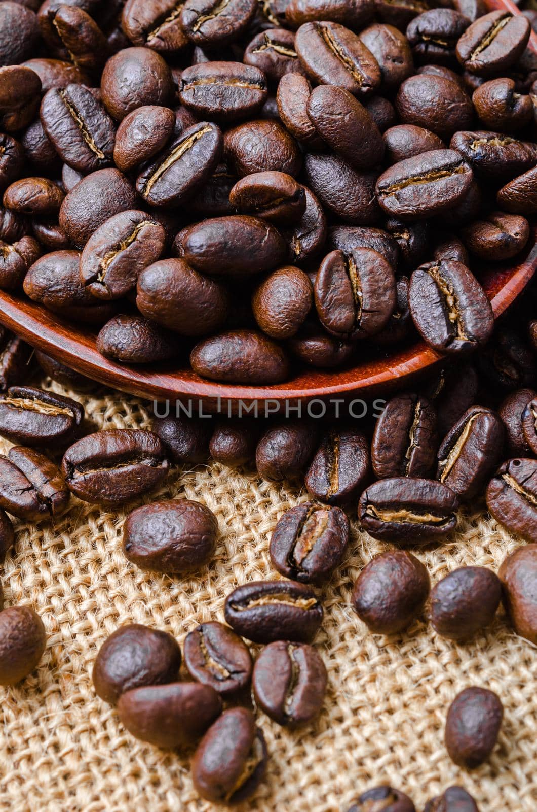Coffee beans on sack. by Gamjai