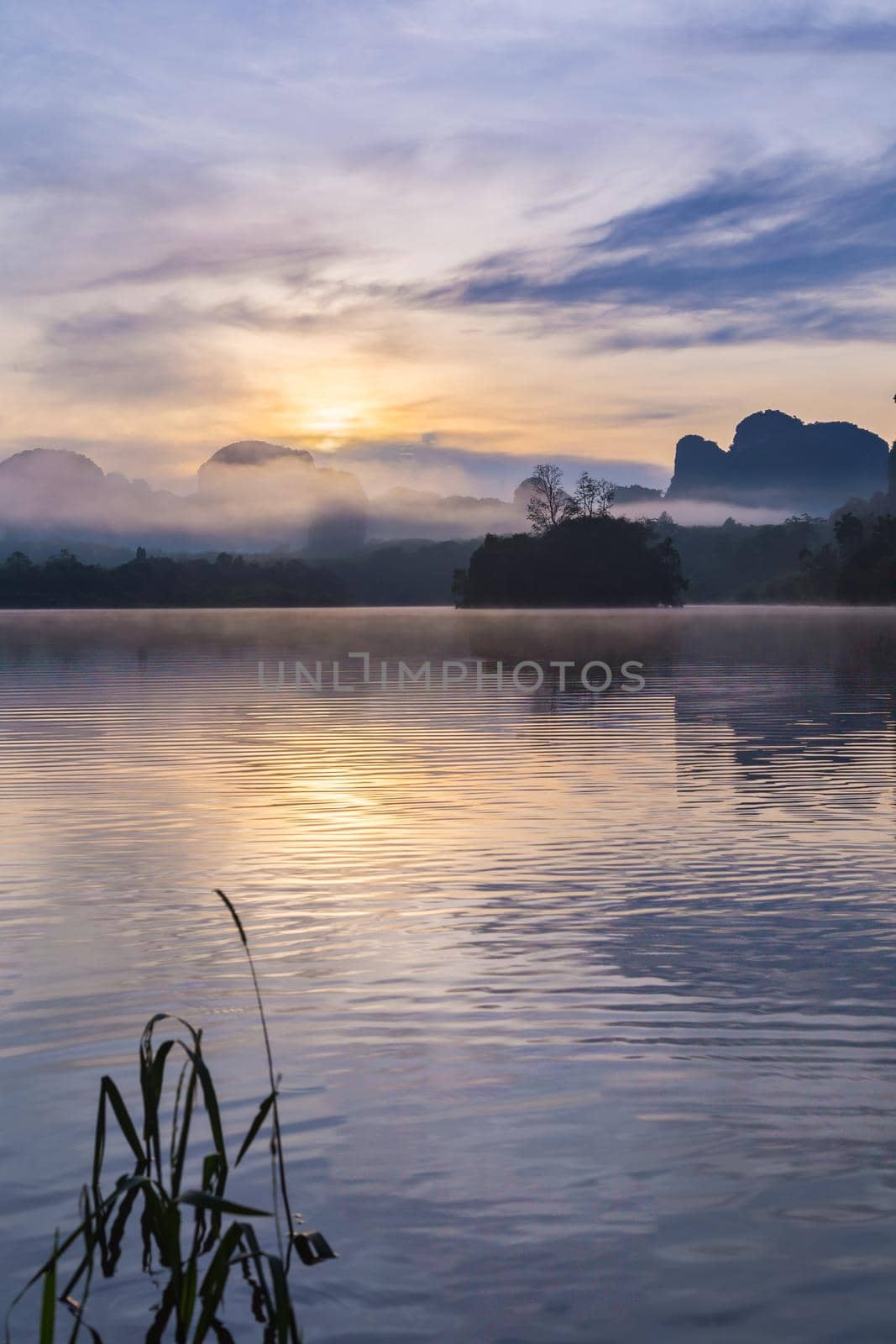 Ban Nong Thale the natural scenery of the sunshine in the morning (mountains, lakes, trees, fog) at Krabi, Thailand.