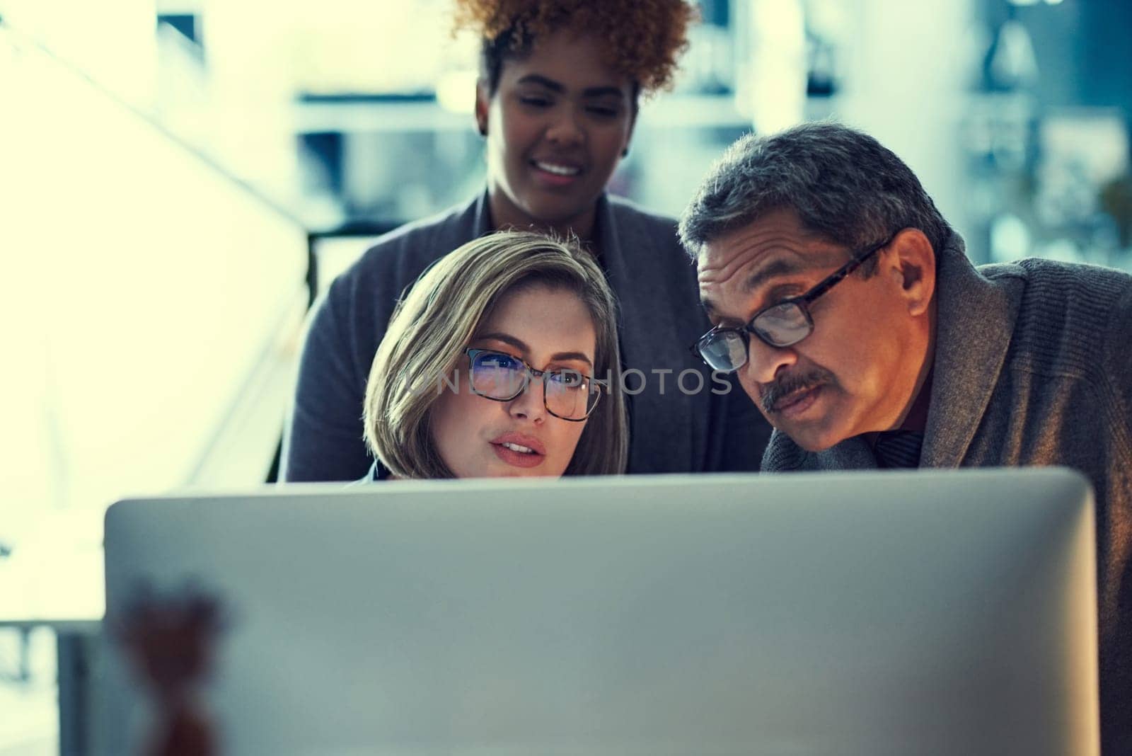 Hard work is the basic ingredient of success. a group of businesspeople working late in an office