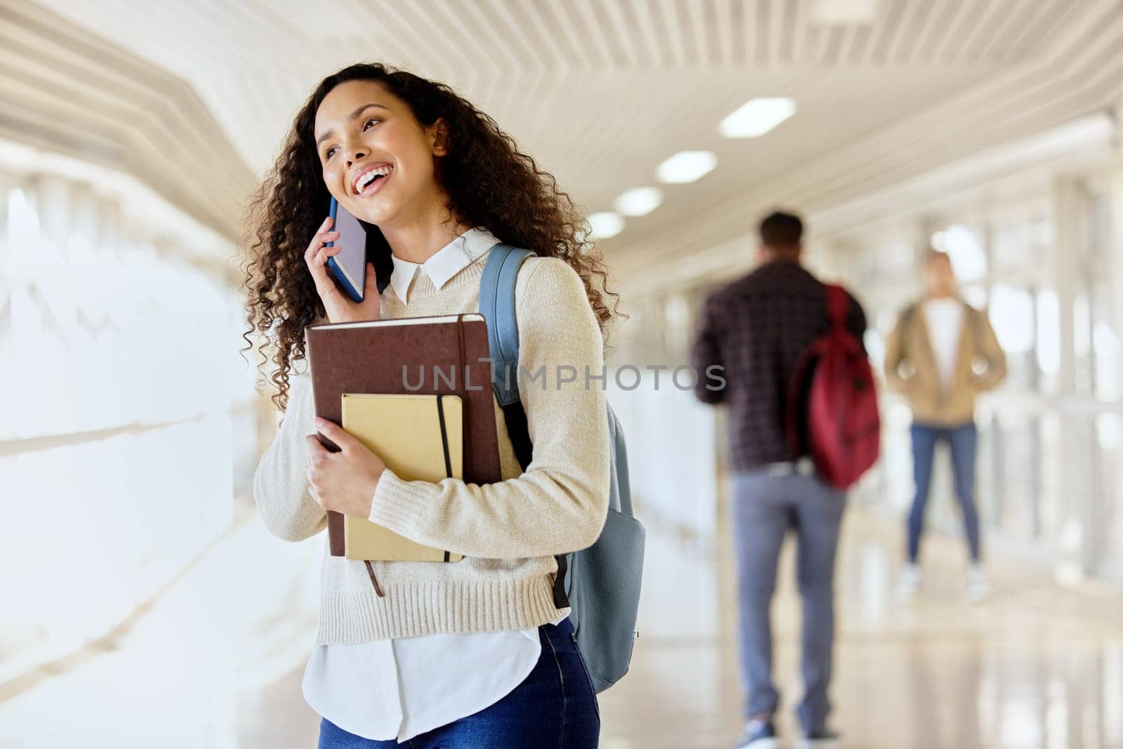 College student, books and woman talking on phone at school for scholarship. Happy african person with backpack and smartphone connection on a call at university for education, learning and knowledge by YuriArcurs