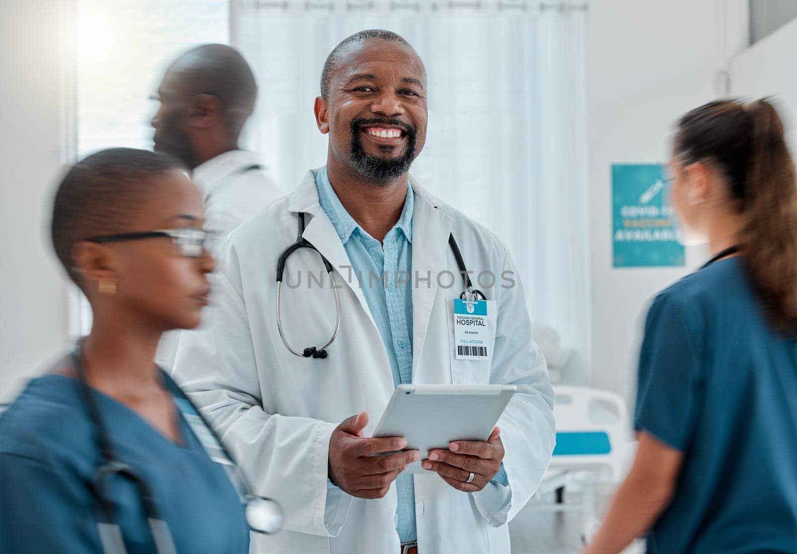 Busy hospital, tablet and portrait of doctor for medical care, wellness app and support with blur of people. Healthcare, digital tech and happy black man for service, consulting and health insurance.