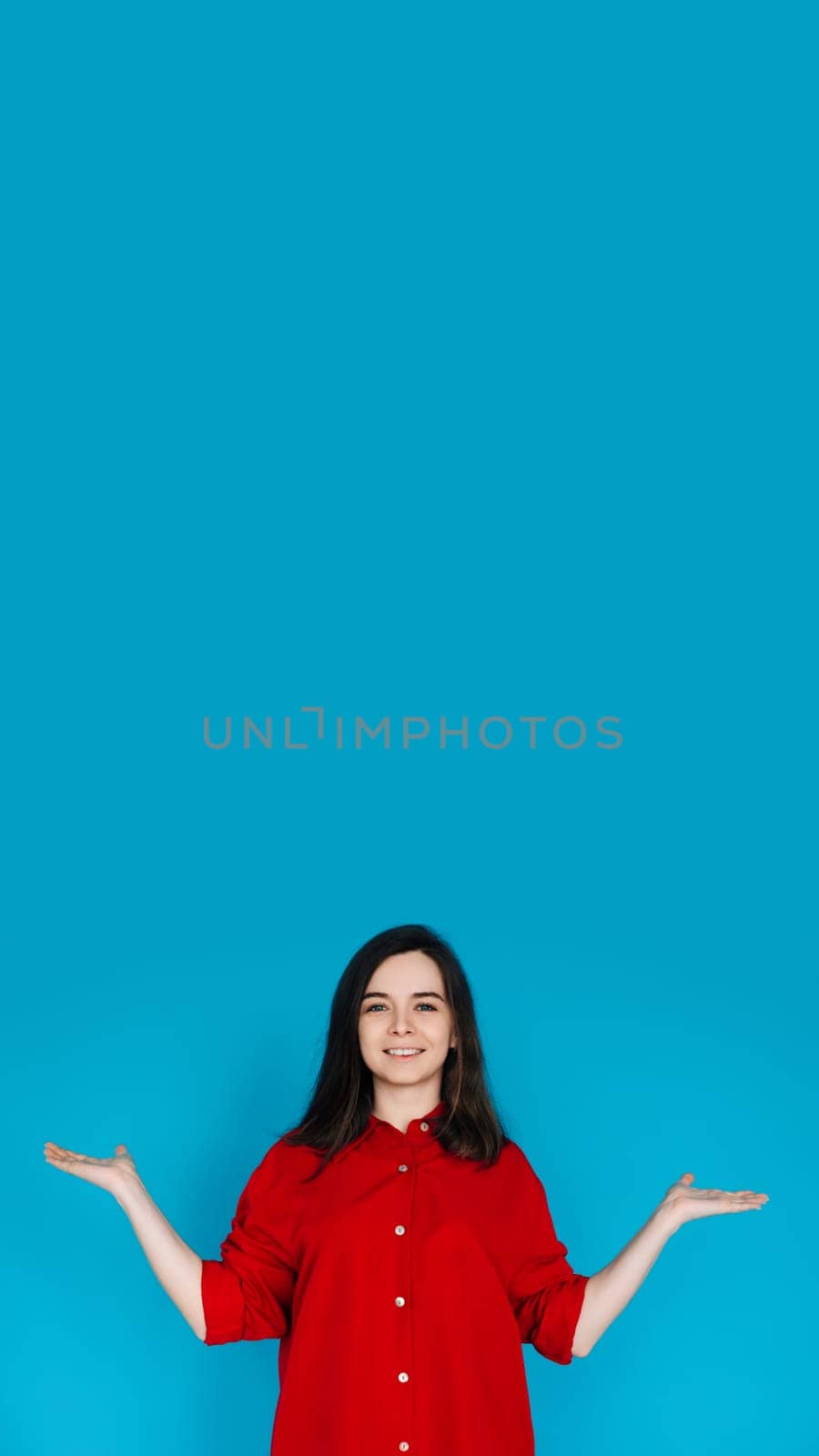 Young Woman Promoter Holding Hand Scales - Solutions, Comparisons, and Measurements - Advertising Concept - Isolated on Blue Background. Compare, Measure, and Advertise.