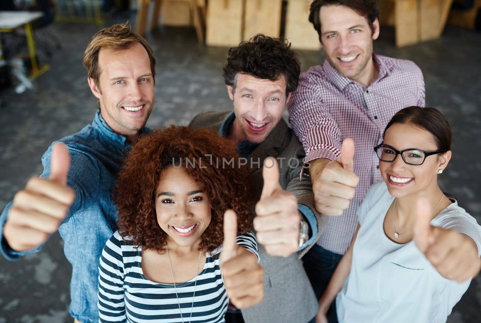 Portrait, thumbs up or happy business people in agreement, support or collaboration together in office. Startup community team, diversity or group of employees with thumb up, yes or like hand gesture by YuriArcurs