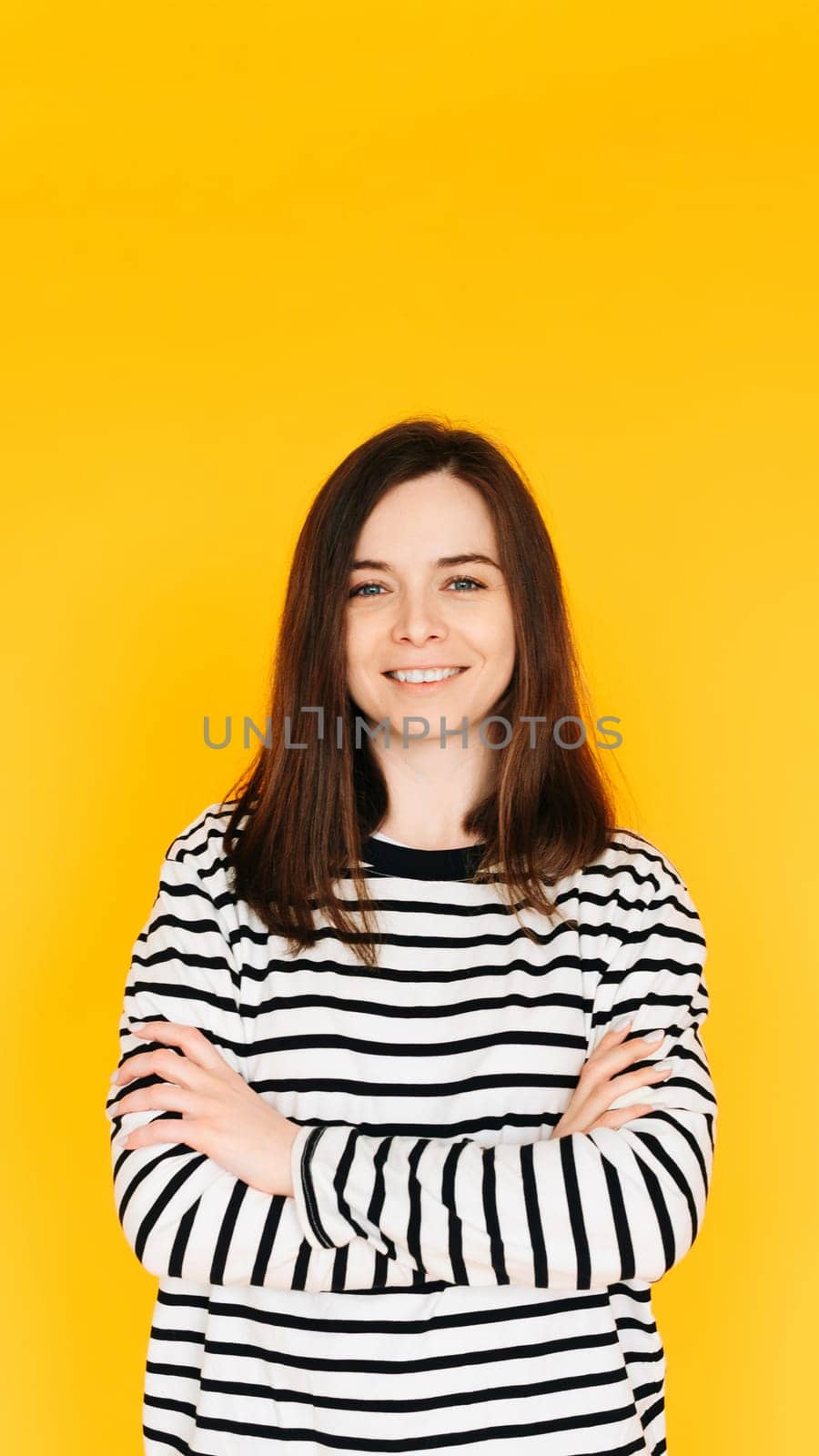 Vision Health Promotion: Positive and Stylish Woman Advocating for Ophthalmology Checkup - Eye Care Awareness Isolated on Vibrant Yellow Background.